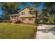 Charming two-story home with a brick facade, manicured lawn, and covered parking at 7639 Northhaven Dr, North Charleston, SC 29420
