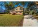 Charming two-story home with a brick facade, manicured lawn, and covered parking at 7639 Northhaven Dr, North Charleston, SC 29420