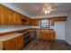 Well-lit kitchen featuring wood cabinets, stainless steel appliances, and modern flooring at 7639 Northhaven Dr, North Charleston, SC 29420