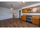 Kitchen showcasing wood cabinets, stainless steel oven, and modern flooring at 7639 Northhaven Dr, North Charleston, SC 29420