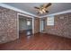 Bright living area featuring brick accent wall and modern flooring at 7639 Northhaven Dr, North Charleston, SC 29420