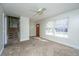 Bright living room with neutral carpet, a fan, and a staircase at 7639 Northhaven Dr, North Charleston, SC 29420