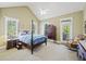 Spacious primary bedroom features natural light, vaulted ceilings, a ceiling fan, and elegant wood furniture at 7938 Pelican Bay Dr, Awendaw, SC 29429