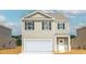 Charming two-story home with gray siding, a two-car garage, and classic black shutters at 838 Lilyford Ln, Summerville, SC 29486