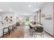 Bright open concept living and dining area with wood flooring and natural light from large windows at 838 Lilyford Ln, Summerville, SC 29486