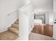 Inviting entryway with carpeted stairs and hardwood floors visible beyond at 9642 Roseberry St, Ladson, SC 29456