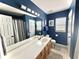 Stylish bathroom with a double vanity, blue walls, and modern fixtures at 9656 Pebble Creek Blvd, Summerville, SC 29485