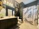 This is a stylish bathroom with a dark color scheme and artistic shower curtain at 9656 Pebble Creek Blvd, Summerville, SC 29485