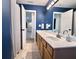 This is a stylish bathroom with a large countertop and blue paint at 9656 Pebble Creek Blvd, Summerville, SC 29485