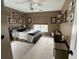 Cozy bedroom with a dark metal bed frame, and neutral carpet. Decorated with animal artwork and vintage toys at 9656 Pebble Creek Blvd, Summerville, SC 29485