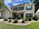 Charming two-story home with green shutters, an American flag, and well-maintained landscaping at 9656 Pebble Creek Blvd, Summerville, SC 29485