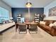A well-lit home office featuring a large wooden desk, comfortable seating, and ample bookshelf space at 9656 Pebble Creek Blvd, Summerville, SC 29485