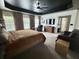 Bright main bedroom featuring a comfortable bed, large windows, and a seating area with a leather chair at 9656 Pebble Creek Blvd, Summerville, SC 29485