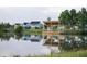 Community pond featuring a wooden dock, covered seating area, and waterfront homes reflecting in the calm water at 972 Carnes Crossing Blvd, Summerville, SC 29486