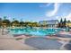 Community swimming pool features clear blue water, lounge chairs, umbrellas, and a barn-style amenity center at 972 Carnes Crossing Blvd, Summerville, SC 29486