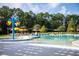 Resort-style community pool with shallow splash area, lounge chairs, yellow umbrellas, and shade pergola at 972 Carnes Crossing Blvd, Summerville, SC 29486