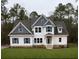 Charming two-story home boasts a well-manicured lawn, white siding, blue accents, and inviting front porch at Ln, Walterboro, SC 29488