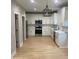 Modern kitchen with white cabinets, stainless steel appliances, stylish light fixture, and bright countertops at Ln, Walterboro, SC 29488