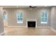 Spacious living room featuring a fireplace, wood-look floors, and two windows offering ample natural light at Ln, Walterboro, SC 29488