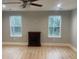 Spacious living room with hardwood floors, bright light, and a traditional fireplace at Ln, Walterboro, SC 29488