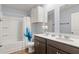 Bathroom featuring a double vanity, decorative mirrors, and a tub with a shower in a well-lit space at 103 Cardinal Flower Ct, Moncks Corner, SC 29461