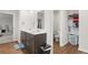 Bright bathroom with a double sink vanity, white counters, a water closet, and hardwood floors at 103 Cardinal Flower Ct, Moncks Corner, SC 29461