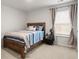 Comfortable bedroom with a wood frame bed, blue bedding, and natural light from the window at 103 Cardinal Flower Ct, Moncks Corner, SC 29461