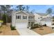 Charming two-story home with a neatly manicured lawn and attached two-car garage and neutral siding at 103 Cardinal Flower Ct, Moncks Corner, SC 29461