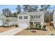 Charming two-story home with a well-manicured lawn and a welcoming entrance at 103 Cardinal Flower Ct, Moncks Corner, SC 29461