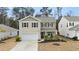 Two-story home featuring a well-kept yard and a two-car garage in a suburban setting at 103 Cardinal Flower Ct, Moncks Corner, SC 29461