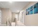 Bright hallway with carpeted floors and stairway, access to rooms, and decorated with modern art at 103 Cardinal Flower Ct, Moncks Corner, SC 29461