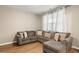 Comfortable living room with a sectional sofa, natural light, and neutral color scheme at 103 Cardinal Flower Ct, Moncks Corner, SC 29461