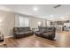 Spacious living room with leather reclining sofas, hardwood floors, lots of light, and view to kitchen at 103 Cardinal Flower Ct, Moncks Corner, SC 29461