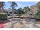 Large backyard with pergola, mature trees and landscaping on sunny day at 108 Tea Farm Rd, Summerville, SC 29483