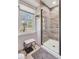 Bathroom with glass shower, neutral tile, garden window, and decorative stool at 108 Tea Farm Rd, Summerville, SC 29483