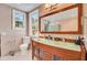 Stylish bathroom with a double vanity, glass countertop, and large mirror at 108 Tea Farm Rd, Summerville, SC 29483