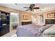 Bedroom showcasing a window with view and dark wood furniture, complemented by a ceiling fan at 108 Tea Farm Rd, Summerville, SC 29483