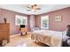 Bedroom with a ceiling fan, hardwood floors, and natural light from two windows at 108 Tea Farm Rd, Summerville, SC 29483