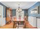 Formal dining room with hardwood floors, elegant chandelier, wainscoting, and large dining table set for eight at 108 Tea Farm Rd, Summerville, SC 29483