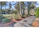 Long driveway leading to the home, surrounded by lush greenery, mature trees, and manicured bushes at 108 Tea Farm Rd, Summerville, SC 29483