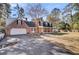Two-story brick home featuring an attached garage, front porch with seating, and spacious lawn at 108 Tea Farm Rd, Summerville, SC 29483