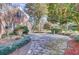 Brick home featuring stone patio, trimmed shrubs and mature landscaping at 108 Tea Farm Rd, Summerville, SC 29483