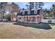 Brick exterior home featuring a covered front porch with comfortable seating and a well-kept lawn at 108 Tea Farm Rd, Summerville, SC 29483