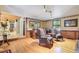 Cozy living room with patterned chairs, a wet bar, hardwood floors and wainscotting at 108 Tea Farm Rd, Summerville, SC 29483