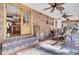 Enclosed patio with brick accent wall, ceiling fans, and view to interior dining area at 108 Tea Farm Rd, Summerville, SC 29483
