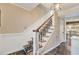 Staircase with patterned carpet, white trim and a decorative light fixture at 108 Tea Farm Rd, Summerville, SC 29483