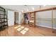 Organized walk-in closet with wood shelving and ample storage, showcasing hardwood flooring at 108 Tea Farm Rd, Summerville, SC 29483