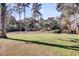 Lush lawn dotted with trees, showcasing a serene and spacious property at 108 Tea Farm Rd, Summerville, SC 29483