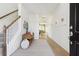 Inviting entryway with hardwood floors, staircase, and a stylish bench creating a warm and welcoming ambiance at 116 Threaded Fern St, Summerville, SC 29485