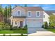 Charming two-story home features a manicured lawn and a two-car garage at 116 Threaded Fern St, Summerville, SC 29485